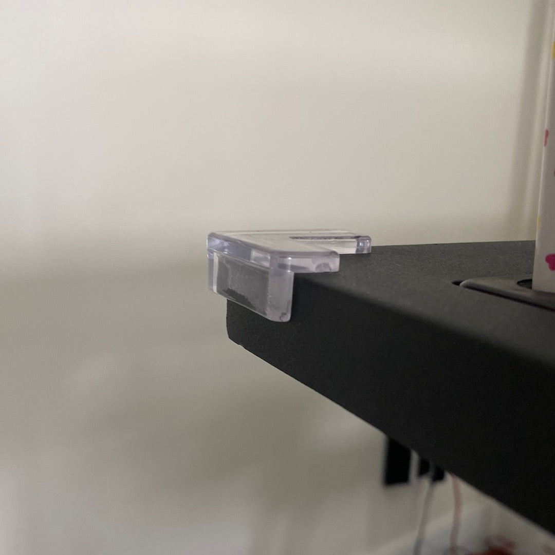 A closer look at the clear corner guard on the sharp edge of a desk.