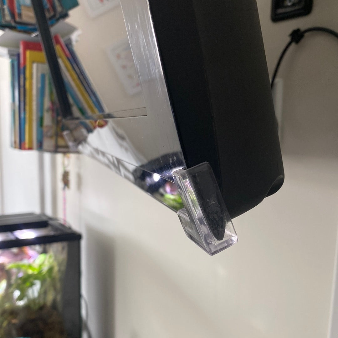 Close look at Clear corner guard on the sharp edge of a swivel TV. Books in background