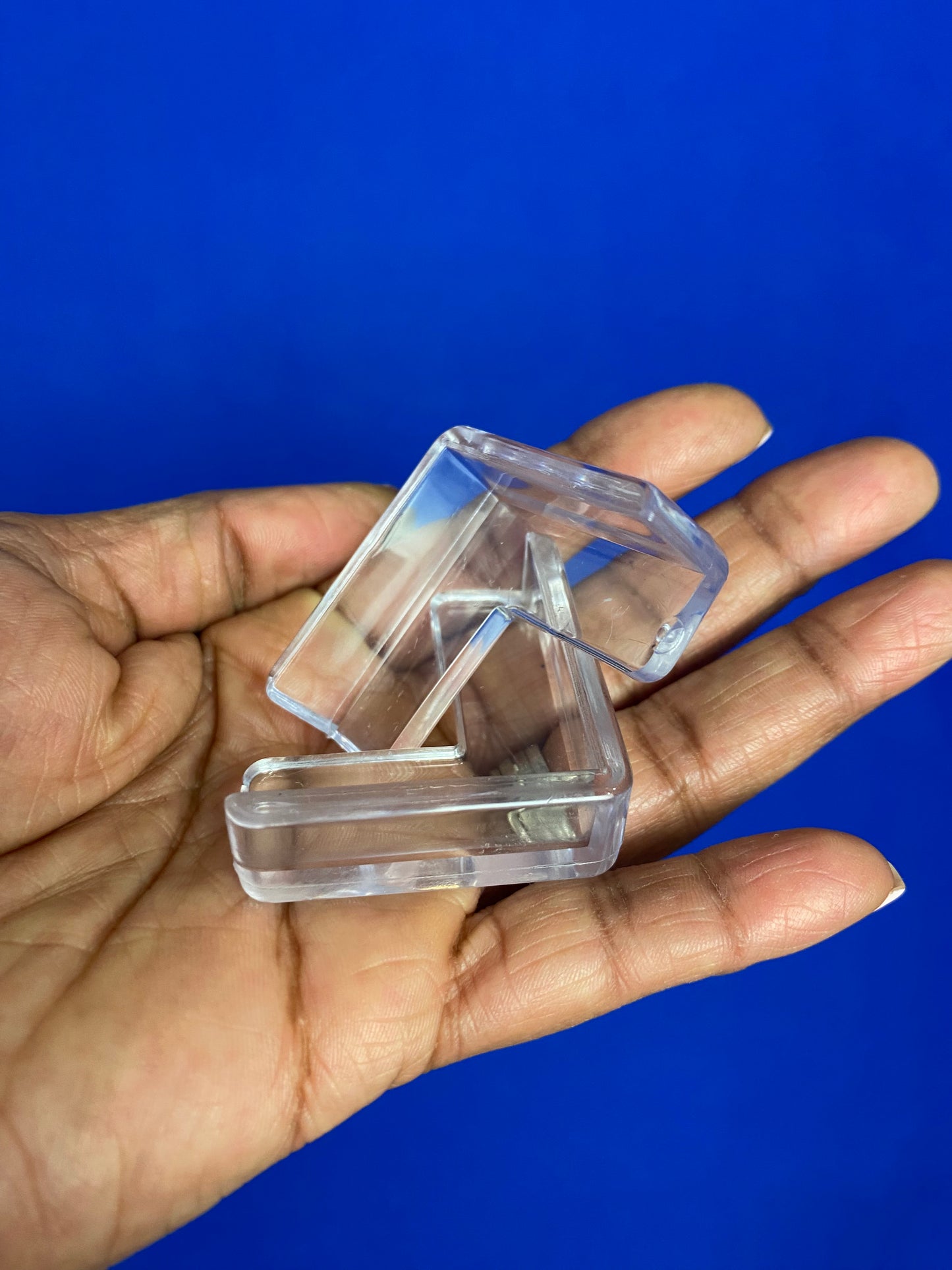 Hand displaying two corner guards at different angle